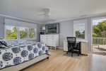 Second floor primary bedroom featuring king size bed and desk